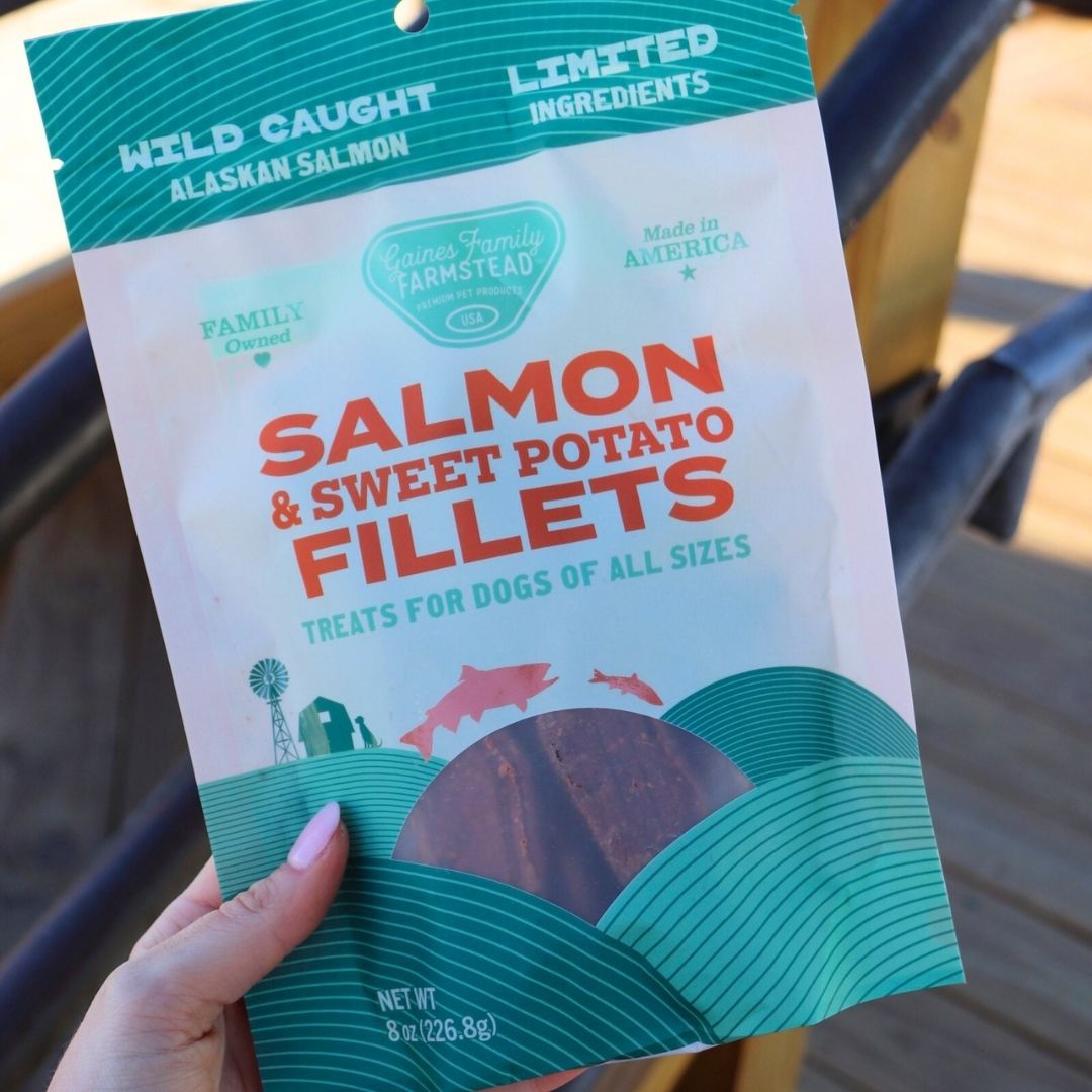 Hand holding a bag of salmon and sweet potato fillets