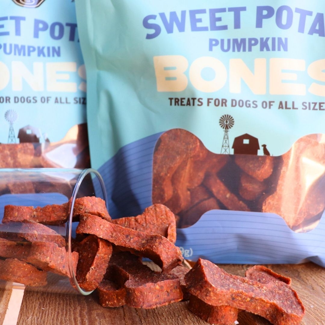 Sweet potato pumpkin bones spilling from a jar beside their bag